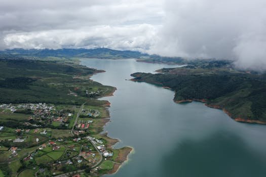 Captivating aerial shot of Calima Lake in Valle del Cauca, Colombia, showcasing lush landscapes and winding shores.